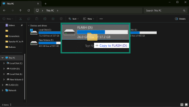 A File Explorer window shows a folder being dragged onto a drive.